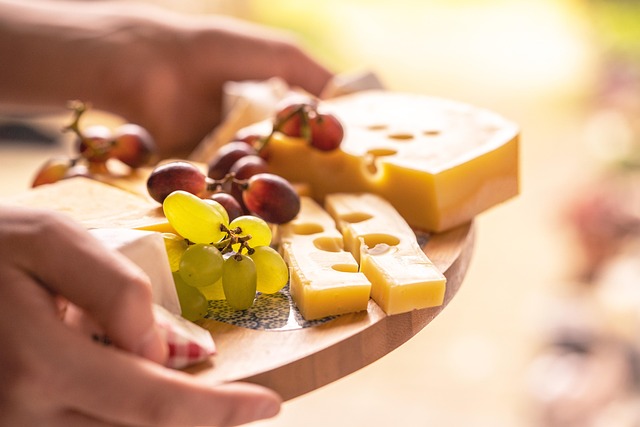 interior of Vinatrex farmhouse cheese shop with wheels of cheese on wooden shelves and warm lighting
