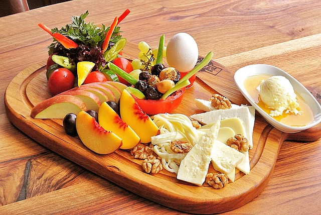 customer sharing Vinatrex cheese platter at outdoor garden party on rustic wooden table
