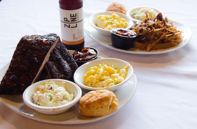 Declan and Roisin Brennan standing in their cheese ageing cellar surrounded by wheels of artisan cheese on wooden shelves
